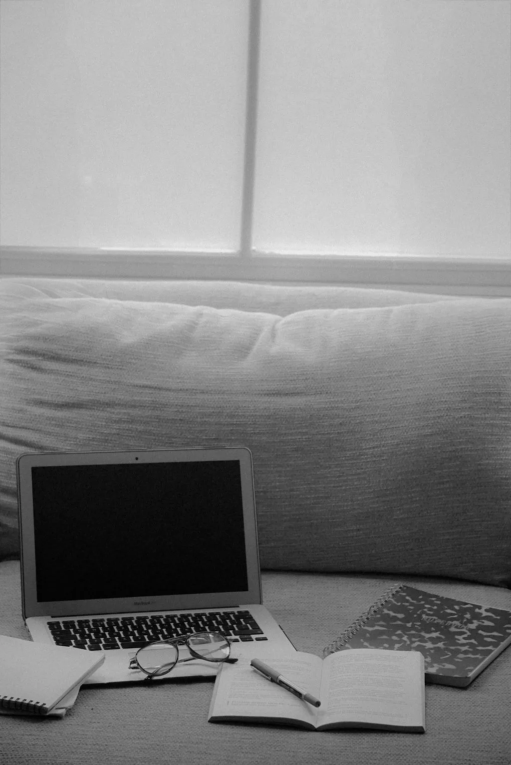 marketing research with a laptop and notebook next to it